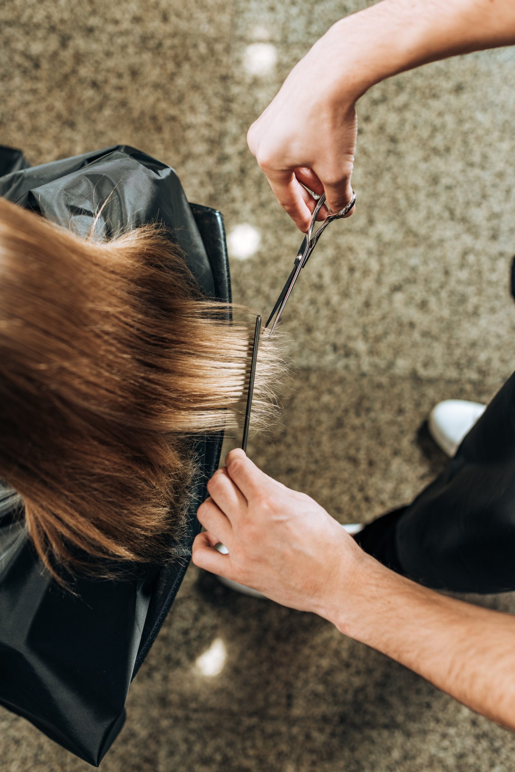 hairdresser cutting woman's hair